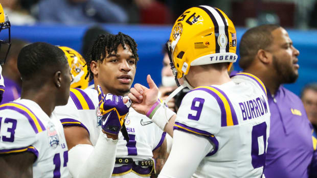 Dec 28, 2019; Atlanta, Georgia, USA; LSU Tigers wide receiver Ja'Marr Chase (1) greets quarterback Joe Burrow (9) before the 2019 Peach Bowl college football playoff semifinal game between the LSU Tigers and the Oklahoma Sooners at Mercedes-Benz Stadium. Mandatory Credit: Jason Getz-USA TODAY Sports