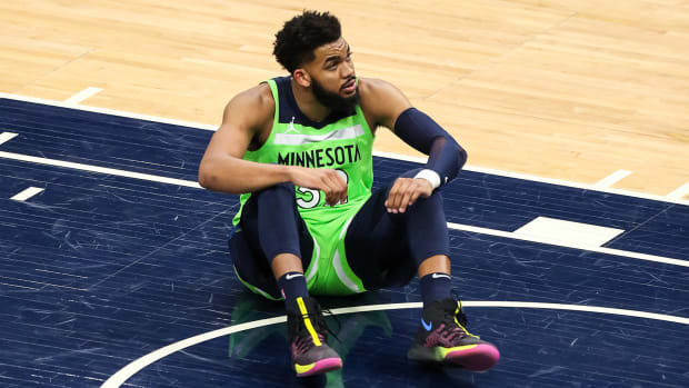 Timberwolves center Karl-Anthony Towns sitting on the court