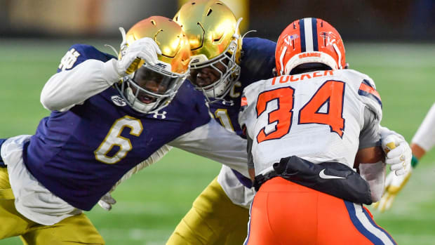 Syracuse Orange running back Sean Tucker (34) is tackled by Notre Dame Fighting Irish linebacker Jeremiah Owusu-Koramoah (6) in the third quarter at Notre Dame Stadium.