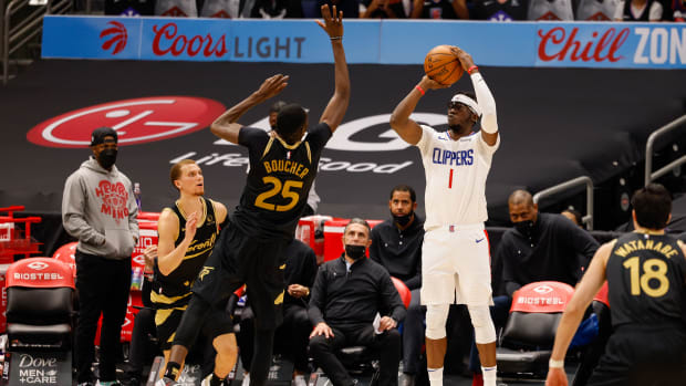 May 11, 2021; Tampa, Florida, USA; LA Clippers guard Reggie Jackson (1) shoots a three-point shot over Toronto Raptors forward Chris Boucher (25) in the third quarter at Amalie Arena. Mandatory Credit: Nathan Ray Seebeck-USA TODAY Sports