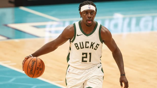 Jrue Holiday brings the ball up court against the Charlotte Hornets.