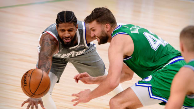 Mar 17, 2021; Dallas, Texas, USA; LA Clippers guard Paul George (13) and Dallas Mavericks forward Maxi Kleber (42) in action during the game between the Dallas Mavericks and the LA Clippers at the American Airlines Center. Mandatory Credit: Jerome Miron-USA TODAY Sports