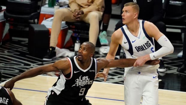May 22, 2021; Los Angeles, California, USA; LA Clippers center Serge Ibaka (9) and Dallas Mavericks center Kristaps Porzingis (6) jockey for rebounding position during the fourth quarter of game one in the first round of the 2021 NBA Playoffs at Staples Center. Mandatory Credit: Robert Hanashiro-USA TODAY Sports