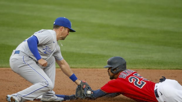 Apr 30, 2021; Minneapolis, Minnesota, USA; Minnesota Twins center fielder Byron Buxton (25) just beats the throw to steal second base as Kansas City Royals second baseman Whit Merrifield (15) applies the tag in the first inning at Target Field. Mandatory Credit: Bruce Kluckhohn-USA TODAY Sports