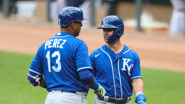 May 30, 2021; Minneapolis, Minnesota, USA; Kansas City Royals second baseman Whit Merrifield (15) celebrates with catcher Salvador Perez (13) after scoring a run against the Minnesota Twins in the first at Target Field. Mandatory Credit: David Berding-USA TODAY Sports
