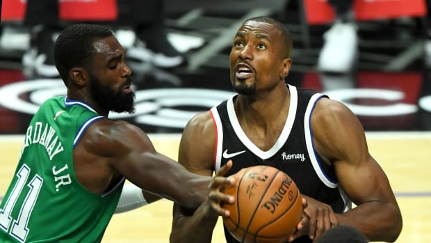 Dec 27, 2020; Los Angeles, California, USA; Los Angeles Clippers forward Serge Ibaka (right) is fouled by Dallas Mavericks guard Tim Hardaway Jr. (11) in the first half at Staples Center. Mandatory Credit: Jayne Kamin-Oncea-USA TODAY Sports