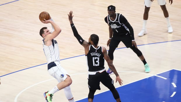 May 30, 2021; Dallas, Texas, USA; Dallas Mavericks guard Luka Doncic (77) shoots over LA Clippers guard Paul George (13) during the second quarter in game four in the first round of the 2021 NBA Playoffs at American Airlines Center. Mandatory Credit: Kevin Jairaj-USA TODAY Sports