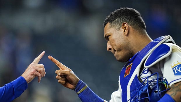 Jun 1, 2021; Kansas City, Missouri, USA; Kansas City Royals catcher Salvador Perez (13) celebrates with first base coach Rusty Kuntz (18) after defeating the Pittsburgh Pirates at Kauffman Stadium. Mandatory Credit: Jay Biggerstaff-USA TODAY Sports