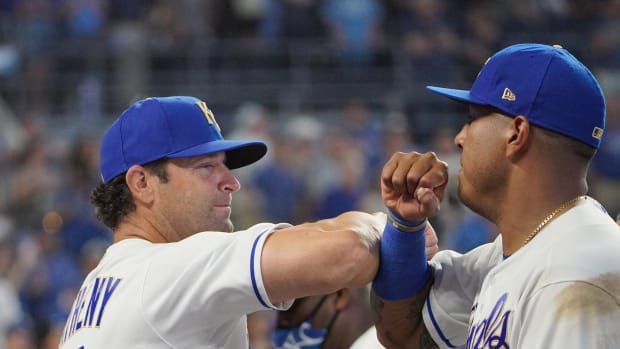 Jun 4, 2021; Kansas City, Missouri, USA; Kansas City Royals manager Mike Matheny (22) celebrates with catcher Salvador Perez (13) after the win over the Minnesota Twins at Kauffman Stadium. Mandatory Credit: Denny Medley-USA TODAY Sports