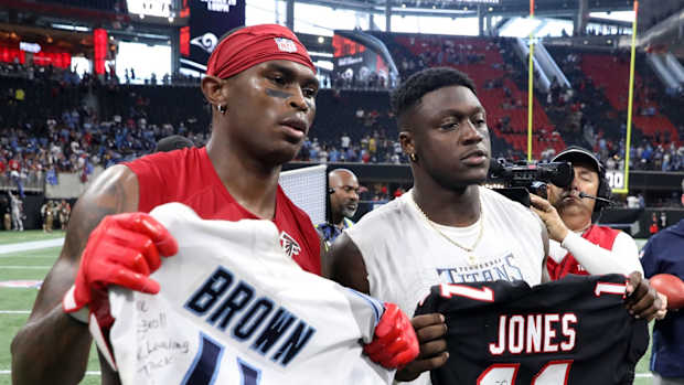 Atlanta Falcons wide receiver Julio Jones (11) and Tennessee Titans wide receiver A.J. Brown (11) pose with their jerseys after their game at Mercedes-Benz Stadium.