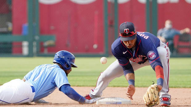 Jun 5, 2021; Kansas City, Missouri, USA; Minnesota Twins second baseman Jorge Polanco (11) misses the throw at second base as Kansas City Royals center fielder Jarrod Dyson (1) dives back in the ninth inning at Kauffman Stadium. Mandatory Credit: Denny Medley-USA TODAY Sports