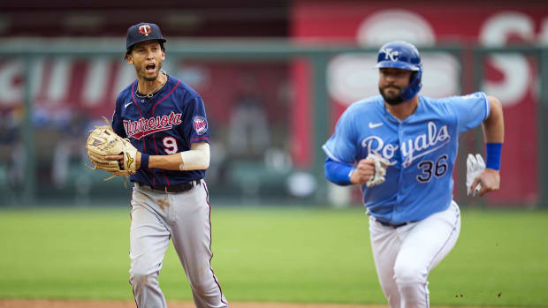 Jun 6, 2021; Kansas City, Missouri, USA; Minnesota Twins shortstop Andrelton Simmons (9) runs down Kansas City Royals catcher Cam Gallagher (36) to complete a triple play during the third inning at Kauffman Stadium. Mandatory Credit: Jay Biggerstaff-USA TODAY Sports