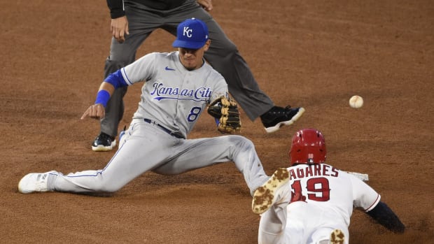 Jun 7, 2021; Anaheim, California, USA; Kansas City Royals shortstop Nicky Lopez (8) is unable to catch the ball while Los Angeles Angels center fielder Juan Lagares (19) steals second base during the fourth inning at Angel Stadium. Mandatory Credit: Kelvin Kuo-USA TODAY Sports