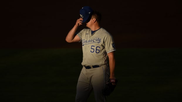 Jun 9, 2021; Anaheim, California, USA; Kansas City Royals starting pitcher Brad Keller (56) puts on his hat during the second inning against the Los Angeles Angels at Angel Stadium. Mandatory Credit: Kelvin Kuo-USA TODAY Sports