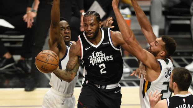 Jun 12, 2021; Los Angeles, California, USA; LA Clippers forward Kawhi Leonard (2) passes the ball while defended by Utah Jazz guard Miye Oni (81) and center Rudy Gobert (27) in the first quarter during game three in the second round of the 2021 NBA Playoffs. at Staples Center. Mandatory Credit: Kelvin Kuo-USA TODAY Sports