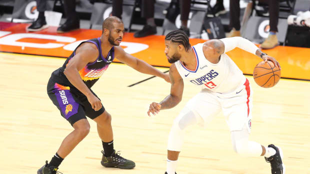 Jan 3, 2021; Phoenix, Arizona, USA; Los Angeles Clippers guard Paul George (13) dribbles against Phoenix Suns guard Chris Paul (3) in the second half at Phoenix Suns Arena. Mandatory Credit: Billy Hardiman-USA TODAY Sports