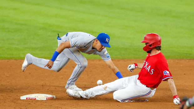 Jun 25, 2021; Arlington, Texas, USA; Texas Rangers third baseman Charlie Culberson (2) slides in under a tag by Kansas City Royals second baseman Nicky Lopez (8) during the sixth inning at Globe Life Field. Mandatory Credit: Andrew Dieb-USA TODAY Sports
