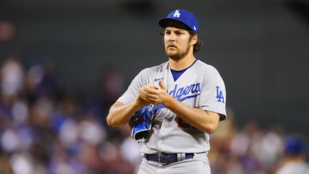 Trevor Bauer grips a baseball in a Dodgers uniform