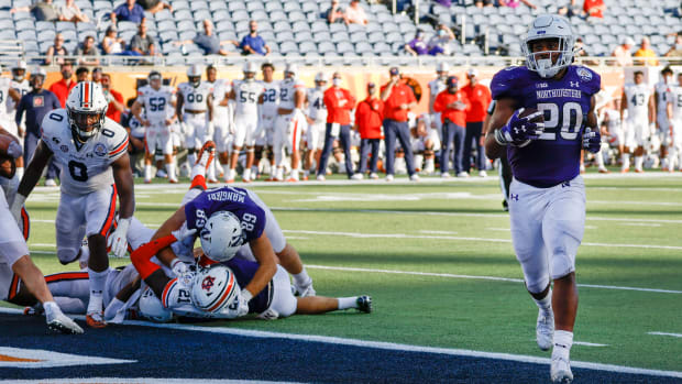 Northwestern Wildcats running back Cam Porter (20) runs it in for the score during the second half against the Auburn Tigers at Camping World Stadium. Reinhold Matay-USA TODAY Sports
