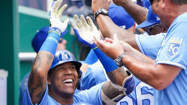 Jul 25, 2021; Kansas City, Missouri, USA; Kansas City Royals designated hitter Salvador Perez (13) is congratulated in the dugout after hitting a three run home run in the first inning against the Detroit Tigers at Kauffman Stadium. Mandatory Credit: Denny Medley-USA TODAY Sports