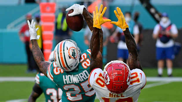 Dec 13, 2020; Miami Gardens, Florida, USA; Miami Dolphins cornerback Xavien Howard (25) makes a one handed catch to intercept a pass intended for Kansas City Chiefs wide receiver Tyreek Hill (10) during the second half at Hard Rock Stadium. Mandatory Credit: Jasen Vinlove-USA TODAY Sports