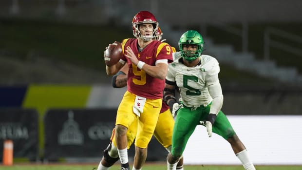Dec 18, 2020; Los Angeles, California, USA; Southern California Trojans quarterback Kedon Slovis (9) is pressured by Oregon Ducks defensive end Kayvon Thibodeaux (5) in the second half during the Pac-12 Championship at United Airlines Field at Los Angeles Memorial Coliseum. Oregon defeated USC 31-24.