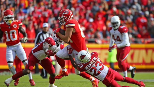 Nov 11, 2018; Kansas City, MO, USA; Kansas City Chiefs tight end Travis Kelce (87) is tackled by Arizona Cardinals linebacker Haason Reddick (43) and cornerback Bene Benwikere (23) in the first half at Arrowhead Stadium. Mandatory Credit: Jay Biggerstaff-USA TODAY Sports