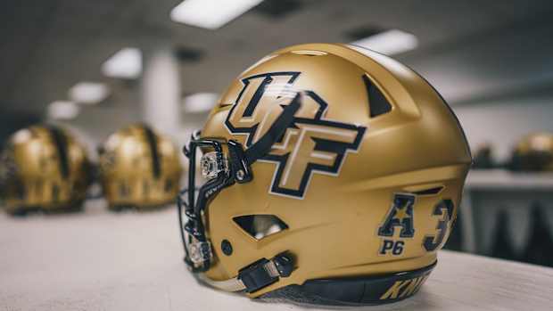 UCF Gold Helmets on Table
