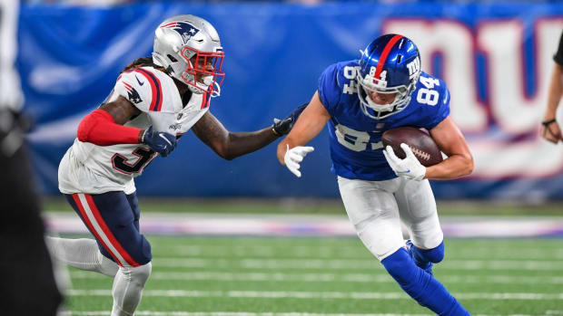 Aug 29, 2021; East Rutherford, New Jersey, USA; New York Giants wide receiver David Sills (84) catches pass and makes a run defended by New England Patriots defensive back Dee Virgin (38) during the third quarter at MetLife Stadium.