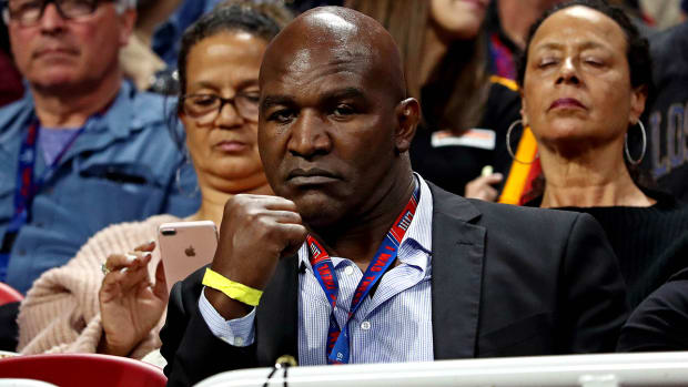 Why is Evander Holyfield back in the ring at 58 years old?