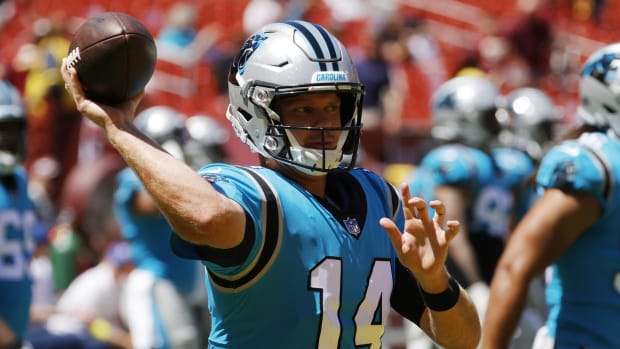 Carolina Panthers quarterback Sam Darnold (14) passes a ball during warmups prior to the game against the Washington Commanders at FedExField.