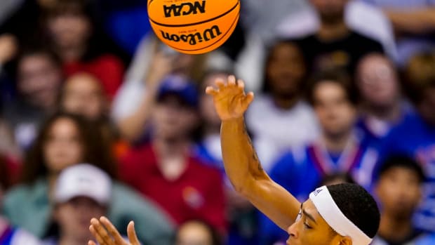 Nov 28, 2022; Lawrence, Kansas, USA; Kansas Jayhawks guard Dajuan Harris Jr. (3) passes the ball as Texas Southern Tigers guard PJ Henry (3) defends during the first half at Allen Fieldhouse.
