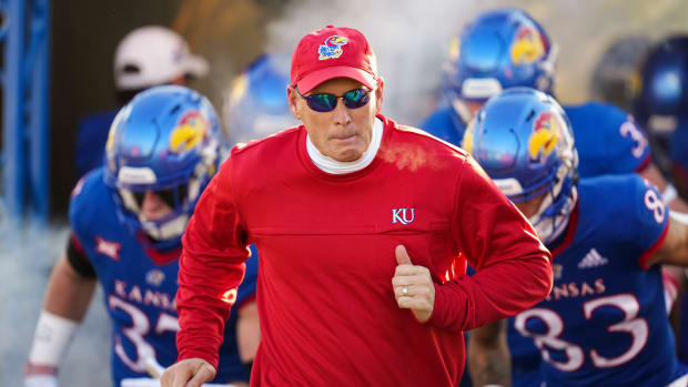 Nov 19, 2022; Lawrence, Kansas, USA; Kansas Jayhawks head coach Lance Leipold leads the team onto the field prior to a game against the Texas Longhorns at David Booth Kansas Memorial Stadium. Mandatory Credit: Jay Biggerstaff-USA TODAY Sports