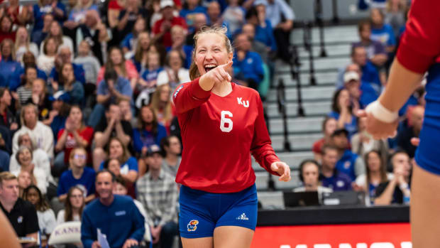 Kansas Jayhawks libero Molly Schultz celebrates with teammates during a match against the Kansas State Wildcats.