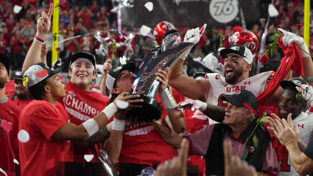 Utah Utes quarterback Cameron Rising hoists the Pac-12 Championship trophy after the game against the Southern California Trojans at Allegiant Stadium.