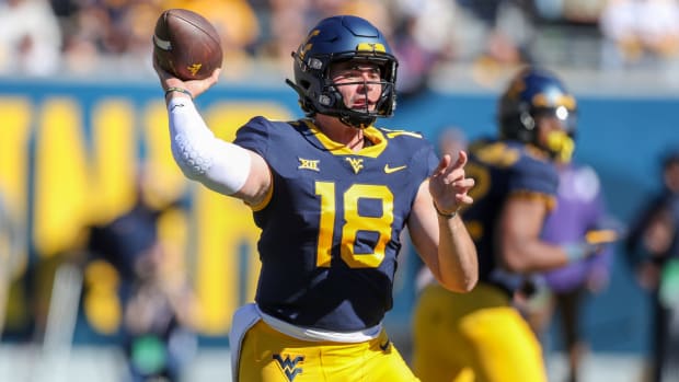 West Virginia quarterback JT Daniels (18) throws a pass during the second quarter of a game against TCU.