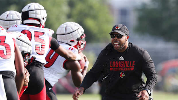 U of L running backs coach De'Rail Sims conducts drills during practice on fan day outside Cardinal Stadium in Louisville, Ky. on Aug. 8, 2021. Uofl13 Sam