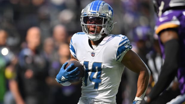 Sep 25, 2022; Minneapolis, Minnesota, USA; Detroit Lions wide receiver Amon-Ra St. Brown (14) runs the ball after a catch from quarterback Jared Goff (not pictured) against the Minnesota Vikings during the first quarter at U.S. Bank Stadium.