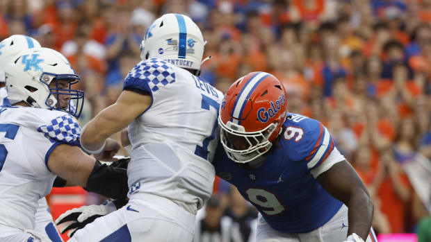 Sep 10, 2022; Gainesville, Florida, USA; Florida Gators defensive lineman Gervon Dexter Sr. (9) tackles Kentucky Wildcats quarterback Will Levis (7) during the first quarter at Ben Hill Griffin Stadium. Mandatory Credit: Kim Klement-USA TODAY Sports