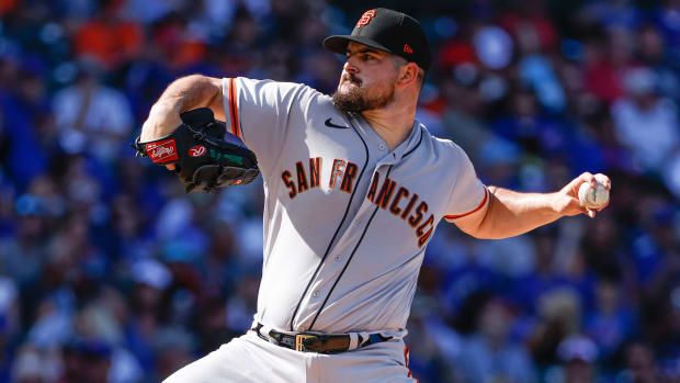 Former San Francisco Giants starting pitcher Carlos Rodón winds up to throw with the ball in hand