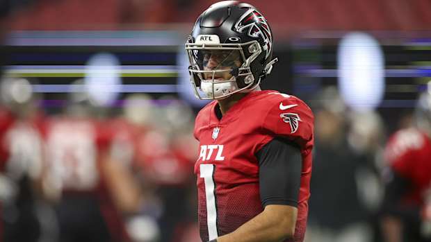 Falcons quarterback Marcus Mariota walks onto the field before a game.
