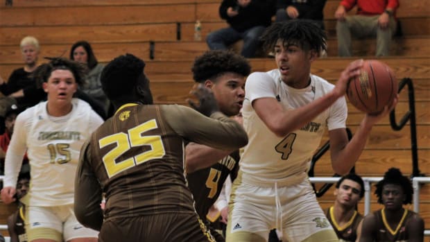 Lloyd Memorial sophomore EJ Walker looks for an opening against Roger Bacon sophomore Jesse Eubanks during Lloyd's 49-42 win in the John Turner Classic Dec. 10, 2022, at Newport High School. Johnturnerclassic5
