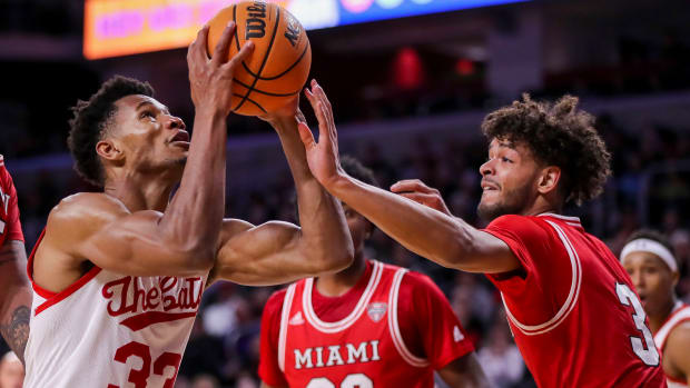 Dec 14, 2022; Cincinnati, Ohio, USA; Cincinnati Bearcats forward Ody Oguama (33) drives to the basket against Miami Redhawks guard Julian Lewis (3) in the first half at Fifth Third Arena. Mandatory Credit: Katie Stratman-USA TODAY Sports