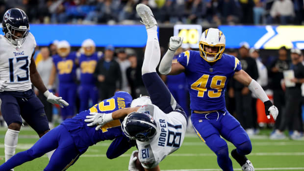 Tennessee Titans tight end Austin Hooper (81) is tackled by Los Angeles Chargers safety Nasir Adderley (24) during the fourth quarter at SoFi Stadium.