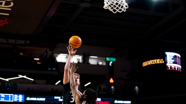 Cincinnati Bearcats forward Viktor Lakhin (30) hits a shot over Detroit Mercy Titans forward Damezi Anderson (23) in the first half of the NCAA men s basketball game at Fifth Third Arena in Cincinnati on Wednesday, Dec. 21, 2022. Ncaa Basketball Detroit Mercy Titans At Cincinnati Bearcats