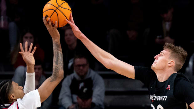 Cincinnati Bearcats forward Viktor Lakhin (30) blocks Detroit Mercy Titans forward Gerald Liddell (11) in the second half of the NCAA men s basketball game at Fifth Third Arena in Cincinnati on Wednesday, Dec. 21, 2022. Cincinnati Bearcats defeated Detroit Mercy Titans 72-54. Ncaa Basketball Detroit Mercy Titans At Cincinnati Bearcats
