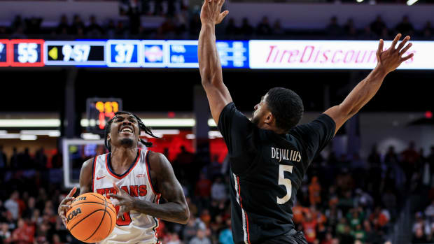 Dec 21, 2022; Cincinnati, Ohio, USA; Detroit Mercy Titans guard Antoine Davis (0) reacts after he draws a foul against Cincinnati Bearcats guard David DeJulius (5) in the second half at Fifth Third Arena. Mandatory Credit: Aaron Doster-USA TODAY Sports