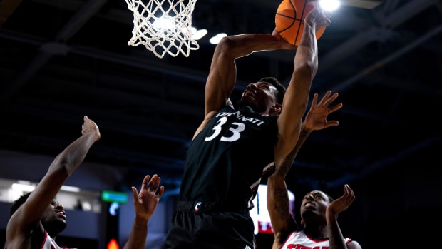 Cincinnati Bearcats forward Ody Oguama (33) hits a shot over Detroit Mercy Titans forward Jordan Phillips (12) and Detroit Mercy Titans guard T.J. Moss (1) in the first half of the NCAA men s basketball game at Fifth Third Arena in Cincinnati on Wednesday, Dec. 21, 2022. Ncaa Basketball Detroit Mercy Titans At Cincinnati Bearcats