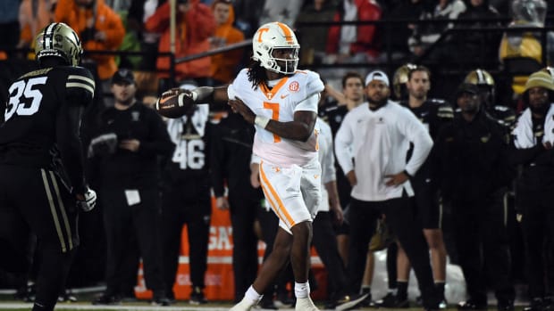 Nov 26, 2022; Nashville, Tennessee, USA; Tennessee Volunteers quarterback Joe Milton III (7) rolls out to pass against the Vanderbilt Commodores during the first half at FirstBank Stadium. Mandatory Credit: Christopher Hanewinckel-USA TODAY Sports