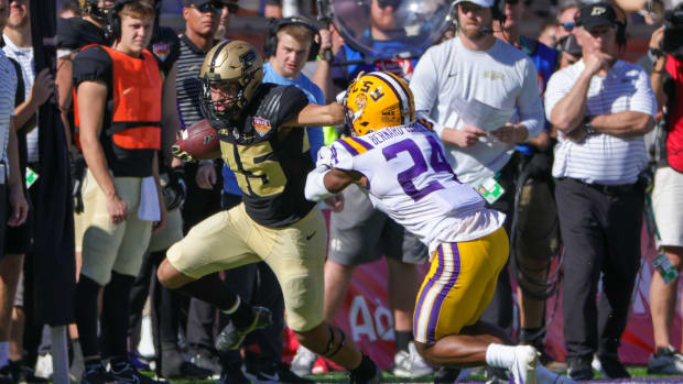 Purdue Boilermakers running back Devin Mockobee (45) is driven out of bounds by LSU Tigers cornerback Jarrick Bernard-Converse (24) during the second quarter at Camping World Stadium.